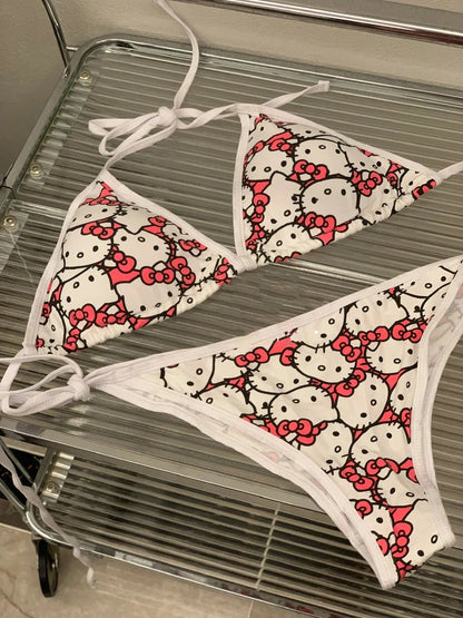 Hello Kitty patterned bikini set on a metal surface