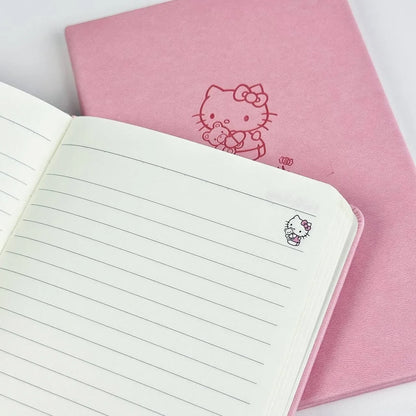 Pink notebook with Hello Kitty design and an open lined notebook on a white background