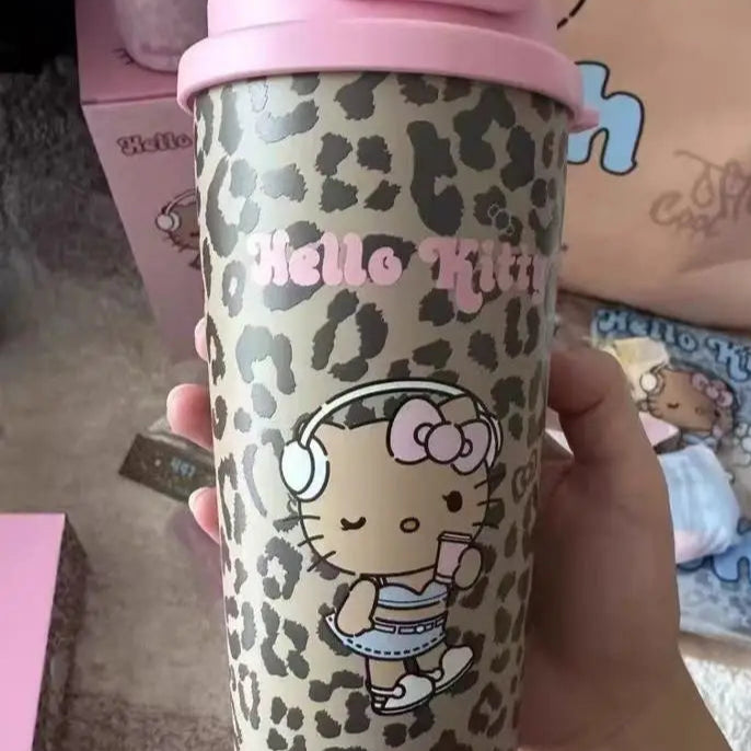 Hello Kitty tumbler with leopard print design held by a hand, with 'Hello Kitty' branding visible.