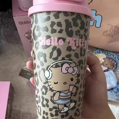 Hello Kitty tumbler with leopard print design held by a hand, with 'Hello Kitty' branding visible.