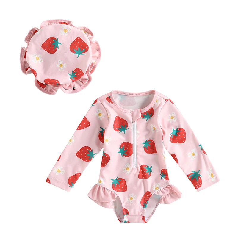 Pink baby swimsuit with strawberry pattern and matching hat on a white background