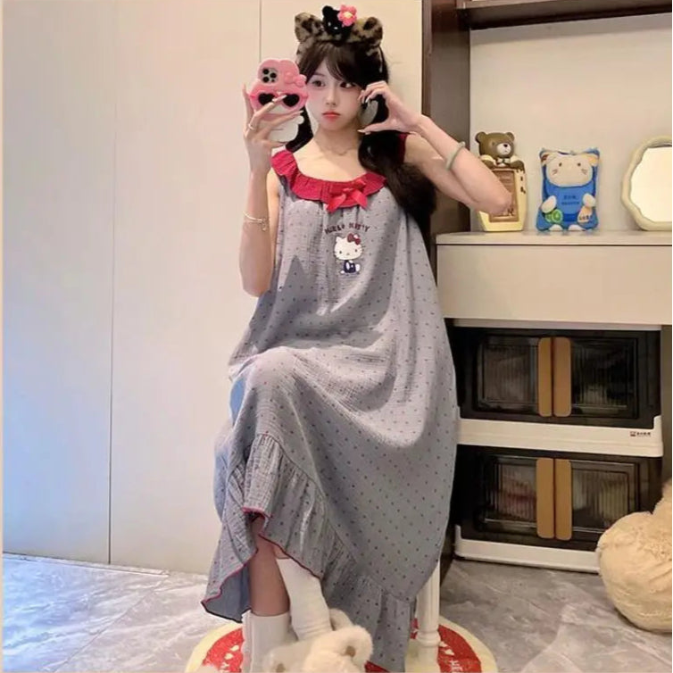 Person wearing a gray dress with a red collar in a room.
