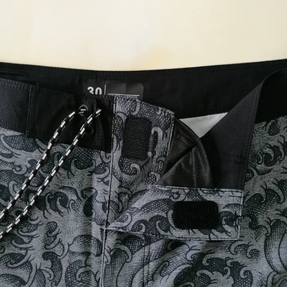 Close-up of a black and gray patterned suit with a brand label.