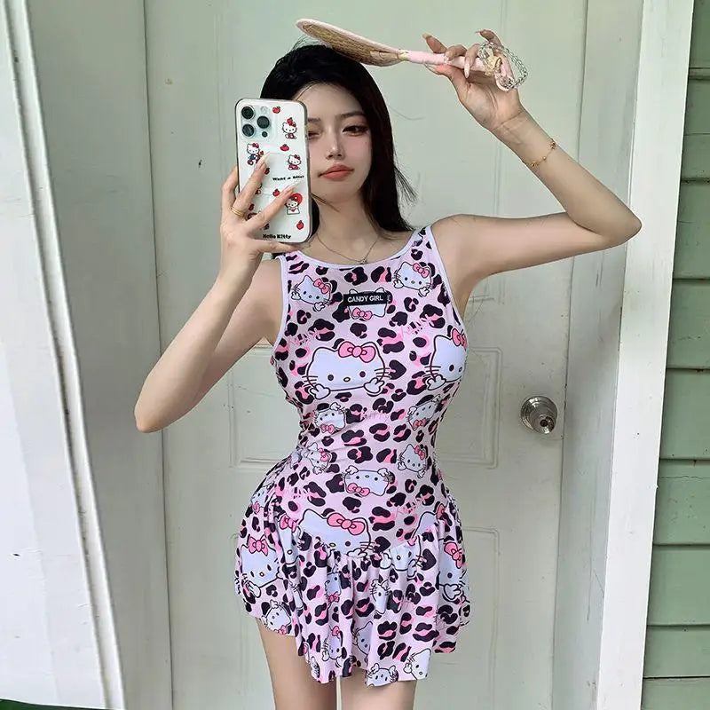 Person wearing a Hello Kitty dress with pink and white pattern, taking a mirror selfie.