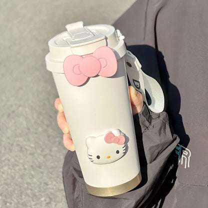 White tumbler with Hello Kitty design held by a person