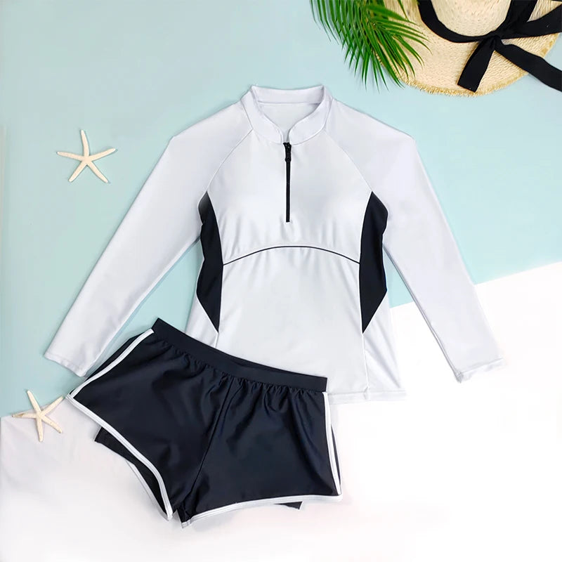 White long-sleeve rash guard and black shorts on a light blue background with starfish and a hat.
