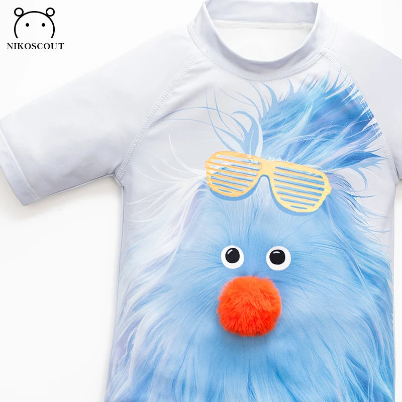Children's t-shirt with a blue creature design and sunglasses on a white background
