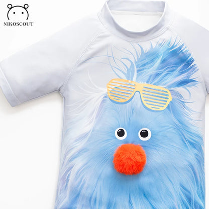 Children's t-shirt with a blue creature design and sunglasses on a white background