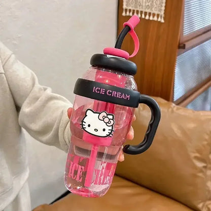 Pink water bottle with Hello Kitty design held by a person indoors.