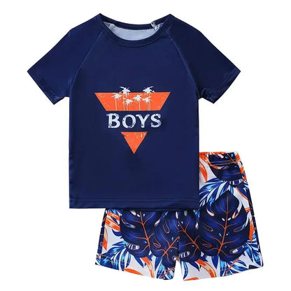 Navy blue shirt with palm tree design and 'BOYS' text, paired with leaf-patterned shorts on a white background.
