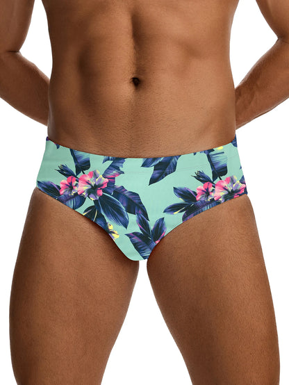 Tropical floral swim briefs worn by a person on a white background