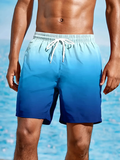Person wearing blue swim shorts with a gradient effect against a blurred water background