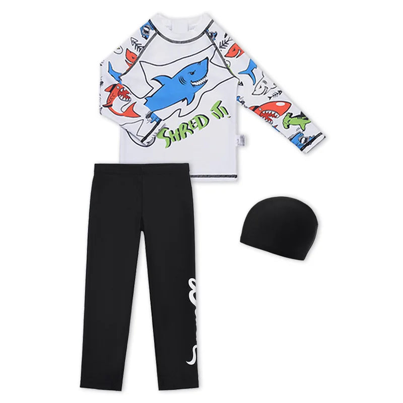 Children's shark-themed rash guard, black pants, and beanie on a white background