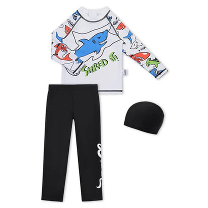 Children's shark-themed rash guard, black pants, and beanie on a white background