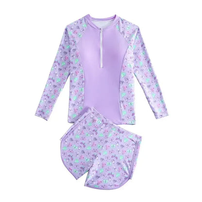 Purple children's swimsuit set with floral pattern on a white background