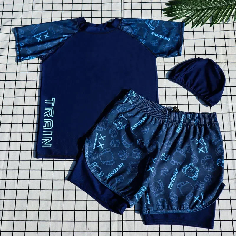 Navy blue children's swim set with patterned shorts on a checkered background