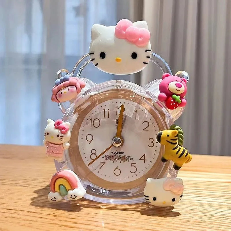 Hello Kitty-themed alarm clock with decorative figures on a wooden surface