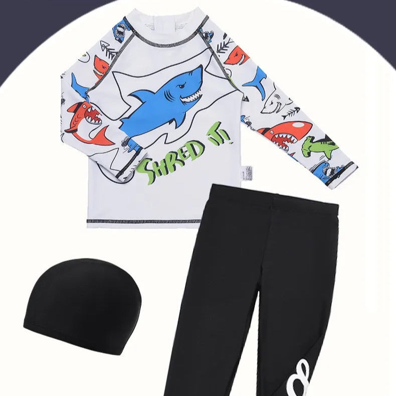 Children's shark-themed swimsuit set with a hat and black pants on a white background