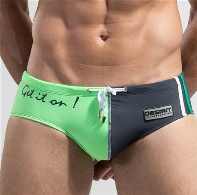 Green and black men's underwear with brand logo on a plain background