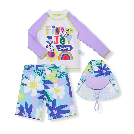 Children's swimsuit set with floral shorts, long-sleeve top, and sun hat on a white background