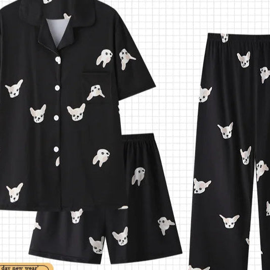 Black pajama set with white dog pattern on a grid background, featuring the brand 'PAJAMSO'.