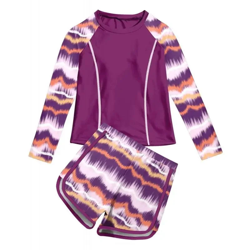Purple long-sleeve rash guard and matching shorts with colorful pattern on a white background