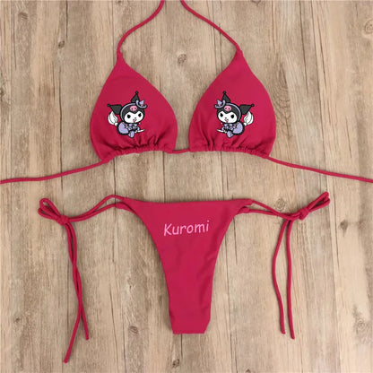 Red bikini set with cartoon character design on a wooden surface