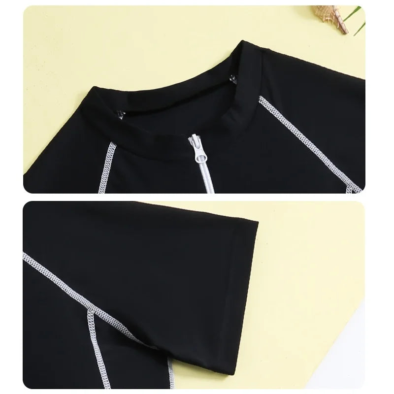 Black swimsuit top with white zipper details on a yellow background