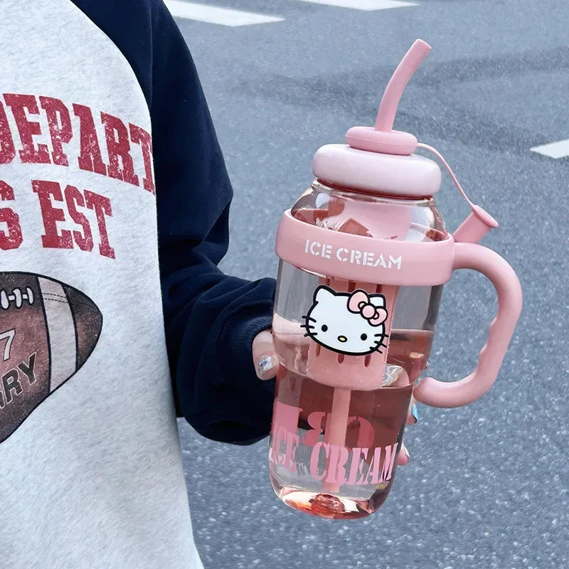 Person holding a pink 'Ice Cream' themed water bottle with a cartoon character design.