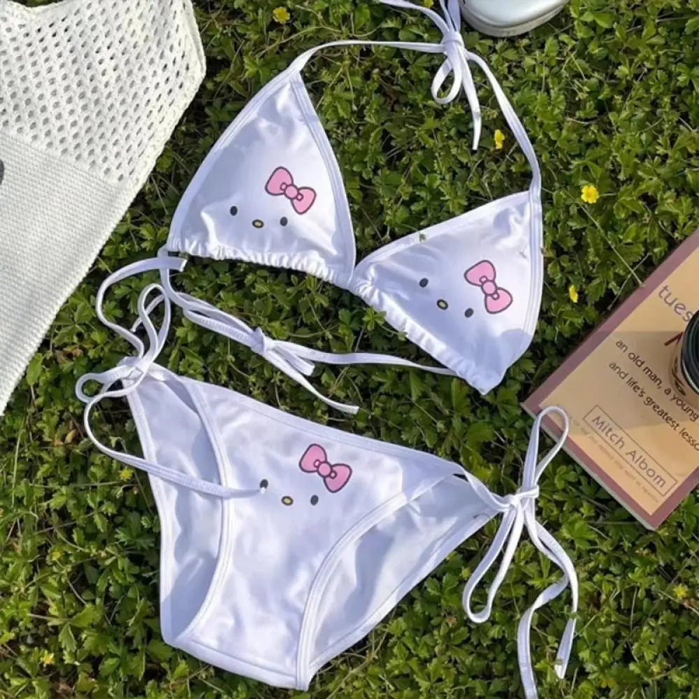 White bikini set with pink bows on grass