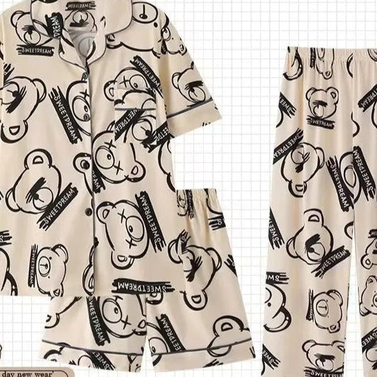 Beige pajama set with black bear and text pattern on a white background with 'PAJAMAS' branding.