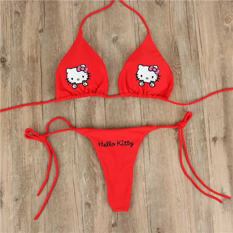 Red bikini set with Hello Kitty design on a wooden surface