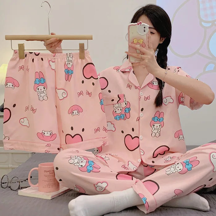 Person wearing a pink cartoon-themed pajama set with matching shorts on a hanger.