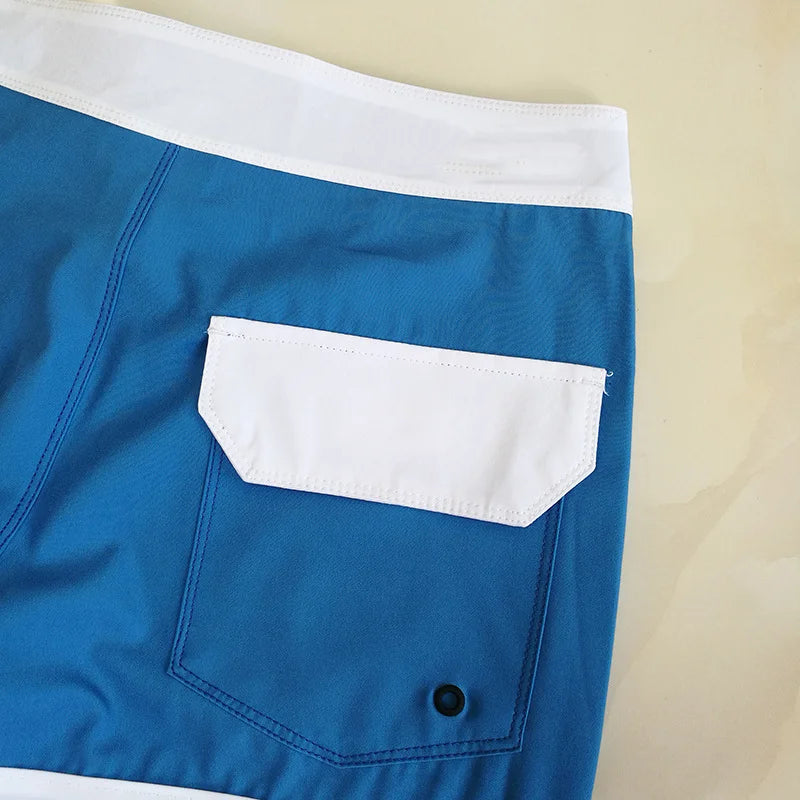 Blue shorts with a white pocket on a beige background