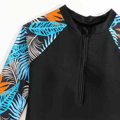 Black hoodie with colorful leaf patterns on sleeves against a white background
