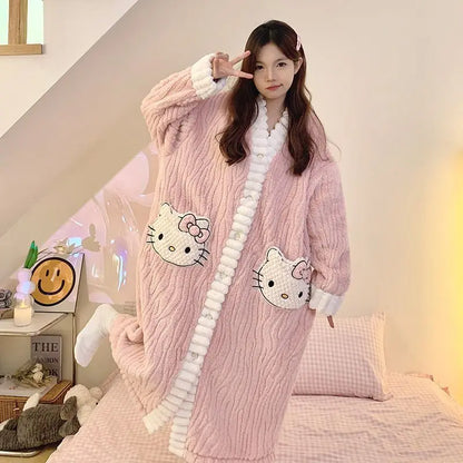 Person wearing a pink plush robe with Hello Kitty designs in a cozy room.