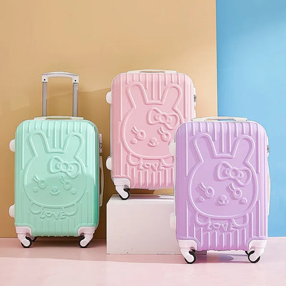Three colorful suitcases with bunny designs on a multicolored background
