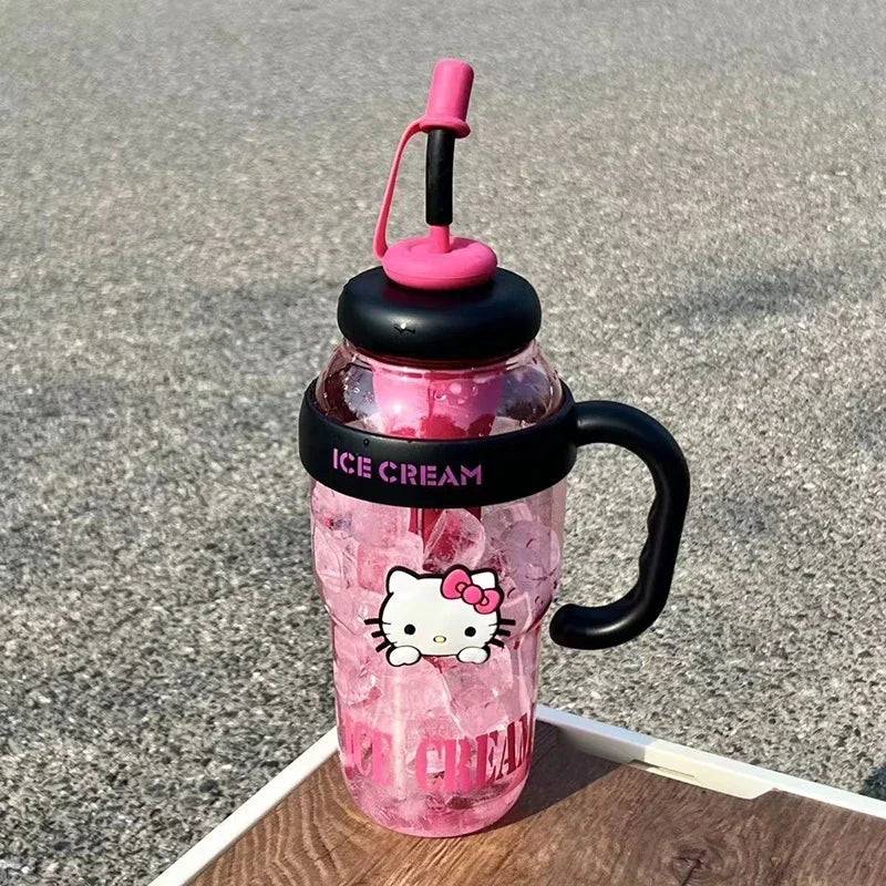 Pink water bottle with black handle and straw lid on a textured surface