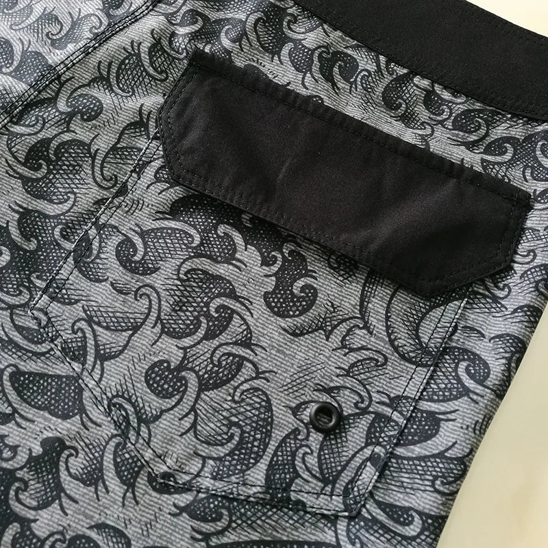 Close-up of a black patterned shirt with a pocket on a textured fabric background
