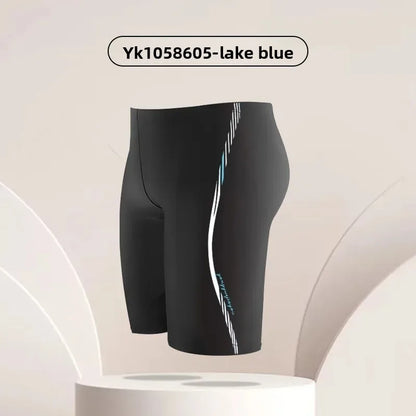 Black swim shorts with a blue stripe on a beige background