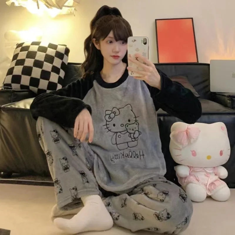 Person wearing Hello Kitty pajamas taking a selfie in a living room with a plush toy.