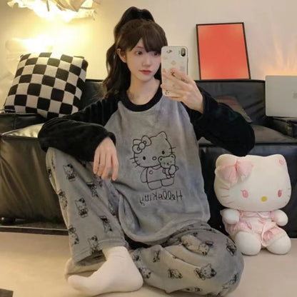 Person wearing Hello Kitty pajamas taking a selfie in a living room with a plush toy.