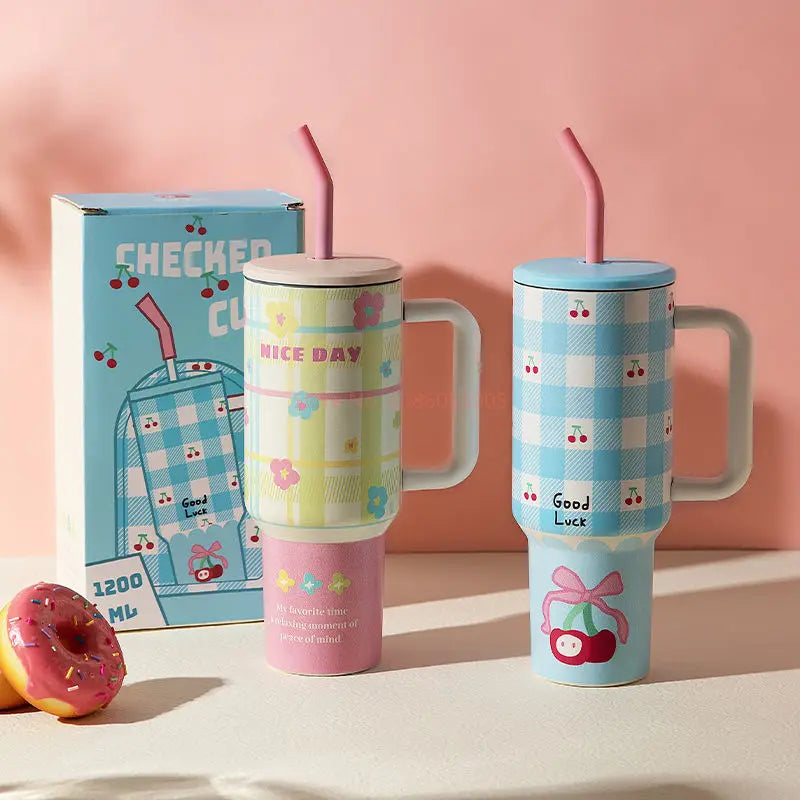 Two colorful tumblers with handles and straws on a pink background