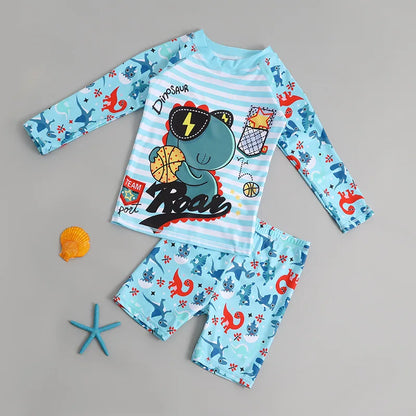 Children's dinosaur-themed pajama set with long-sleeve top and shorts on a gray background.