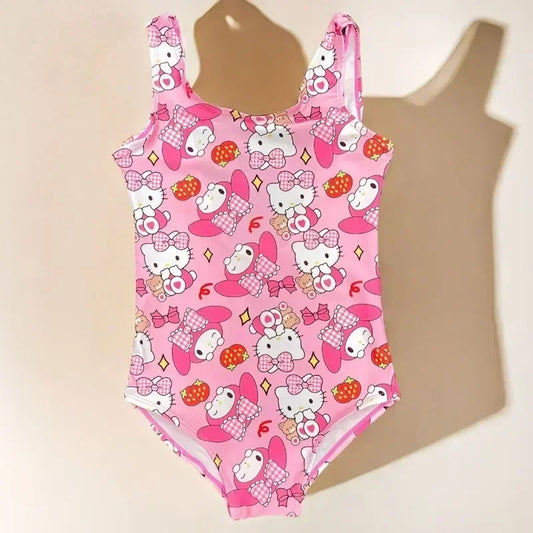 Pink children's swimsuit with Hello Kitty pattern on a beige background