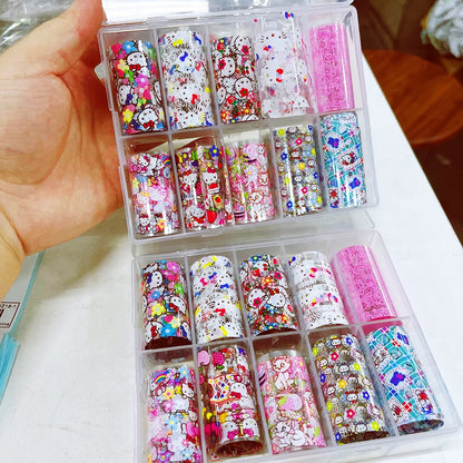 Colorful nail art decorations in a transparent case held by a hand.