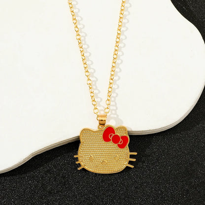 Gold Hello Kitty pendant necklace on a white and black background