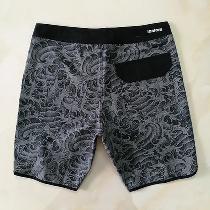 Gray patterned shorts with a black waistband on a light background