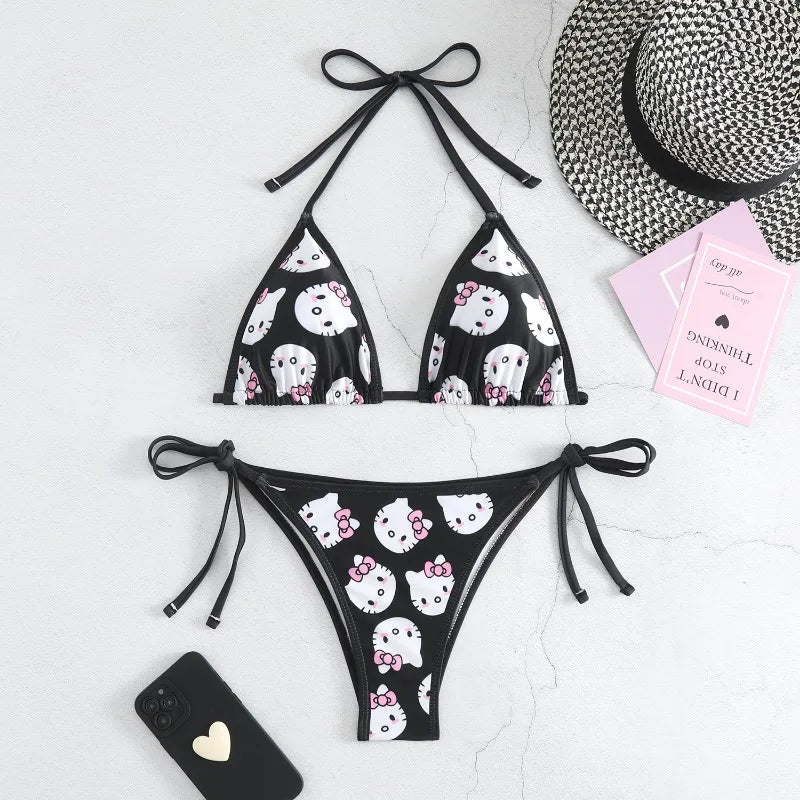 Black bikini set with white cat print on a light gray background