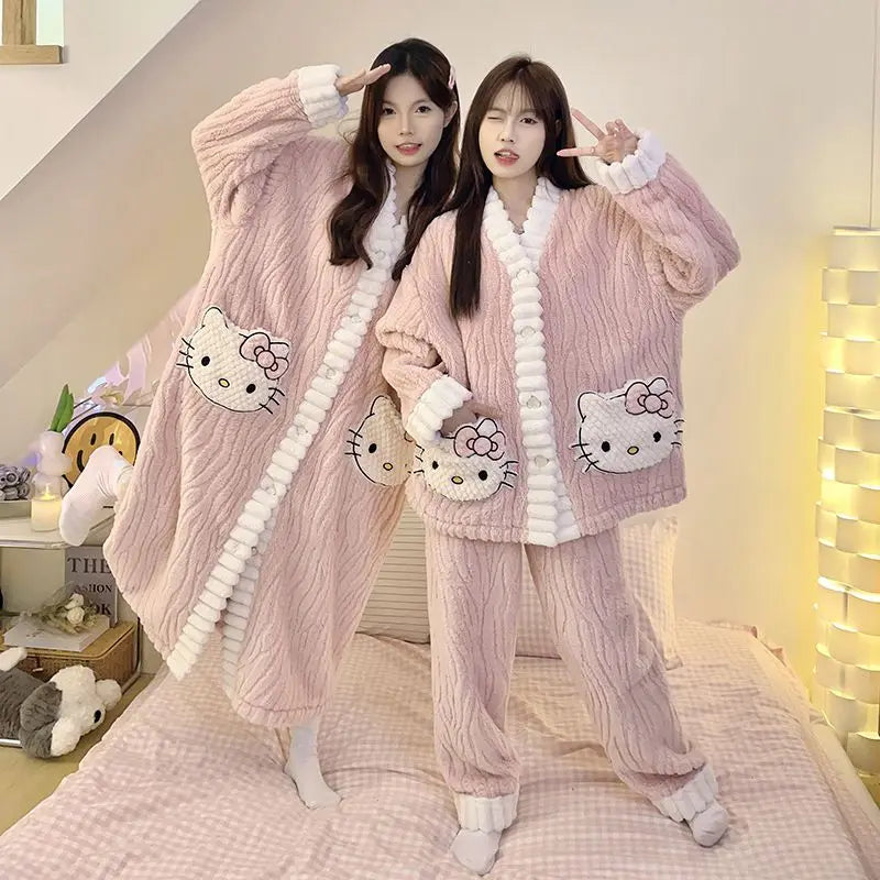 Two people wearing pink Hello Kitty pajamas in a cozy room.